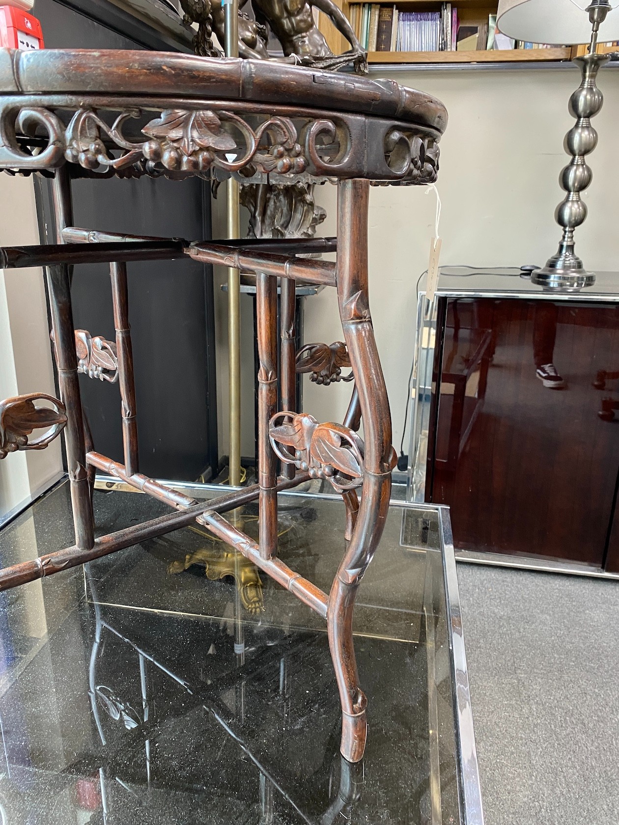 A Chinese circular hardwood tray top occasional table on folding stand, diameter 62cm, height 70cm